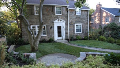 green grass, landscaped yard, house on a hill